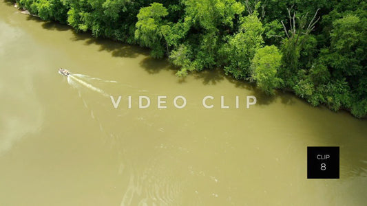 CLIP 8 - Chattahoochee River - fisherman motoring up river beside green forest at Franklin, GA