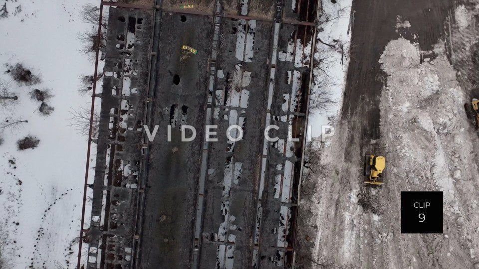 CLIP 9 - Buffalo, NY construction tractor plows snow beside abandoned building after winter storm