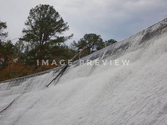 Photo - Water spilling over dam after rainfall