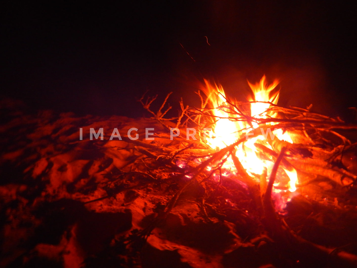 Photo - Camp fire on sandy river bank