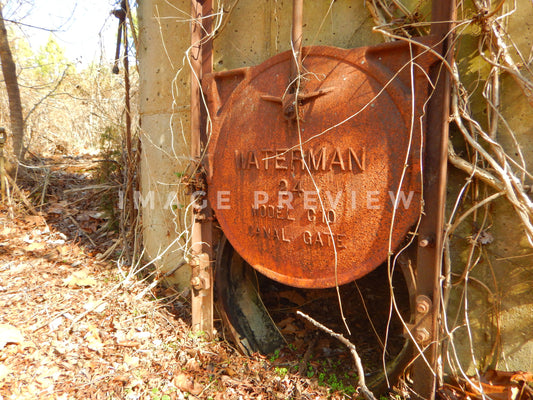 Photo - Old drainage pipe rusting beside lake