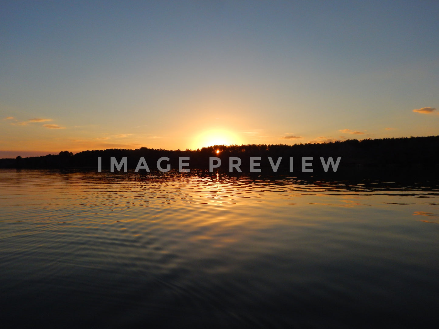 Photo - Sunset over calm lake water