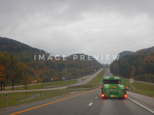 Photo - Cloudy skies while driving down interstate highway