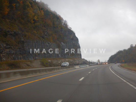 Photo - Overcast sky while traveling down interstate highway