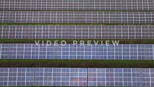 Video - Aerial passing over solar ponels generating renewable energy